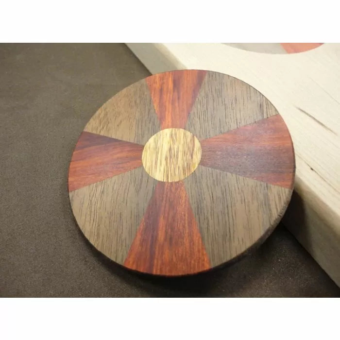 Round segmented wood coaster with alternating dark and reddish wood sections