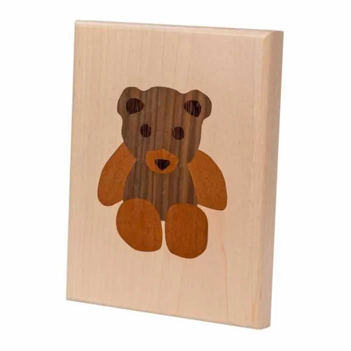 Wood inlay teddy bear design plaque for woodworking projects.