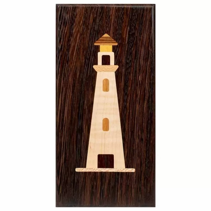 Wood inlay lighthouse design on a dark rectangular wood plaque, woodworking project example
