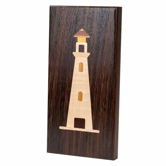 Wood inlay lighthouse design on dark rectangular wood plaque, woodworking project sample