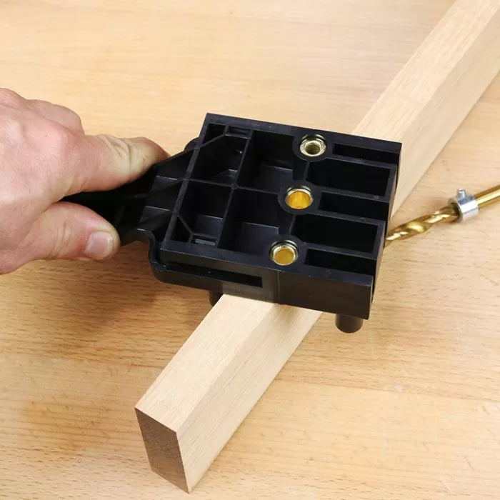 Pocket hole jig guide held on wood for woodworking joinery with drill bit