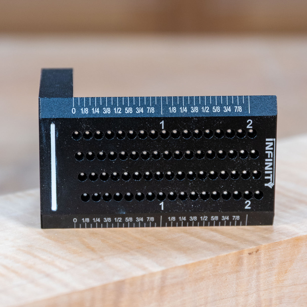 Black aluminum woodworking saddle square with drill guide holes and etched ruler markings