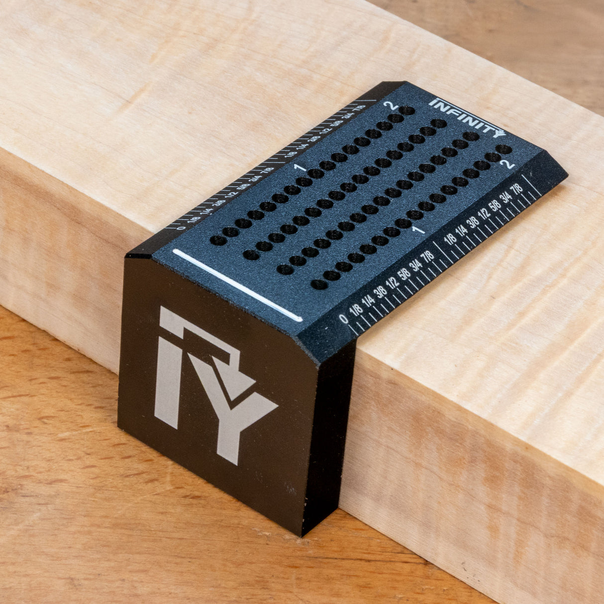 Aluminum saddle square woodworking marking tool with precision holes and ruler on wood