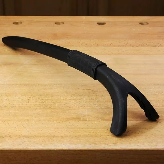 Black plastic bench dog push stick for woodworking on a wooden workbench
