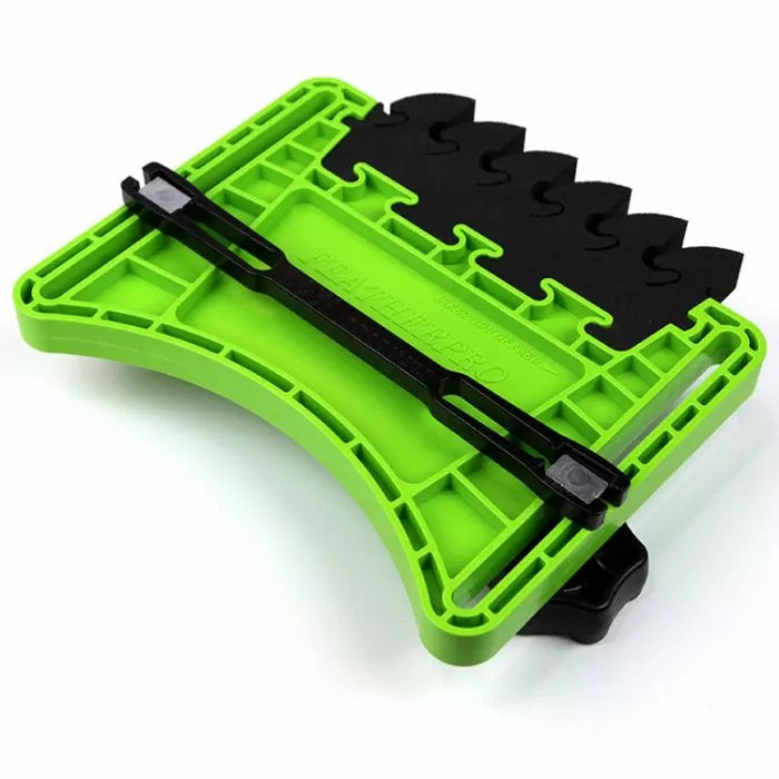 Green plastic featherboard for router table with black adjustable fingers for woodworking safety