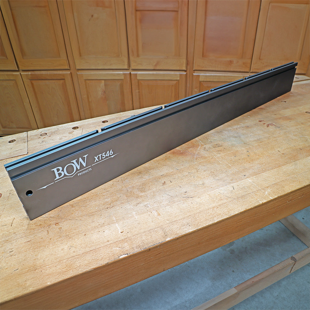 BOW XT546 aluminum router table fence on a wooden workbench in a workshop setting