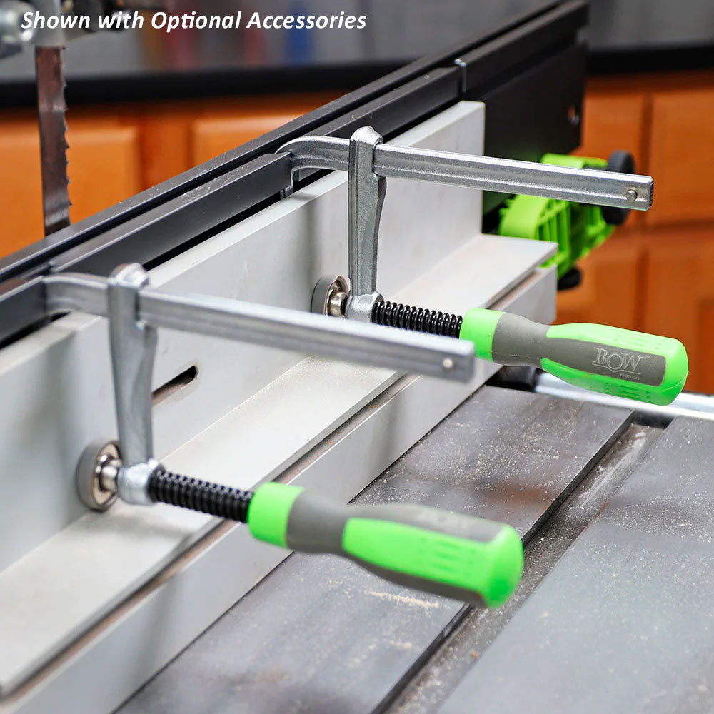 F-style woodworking clamps with green handles securing fence on a table saw