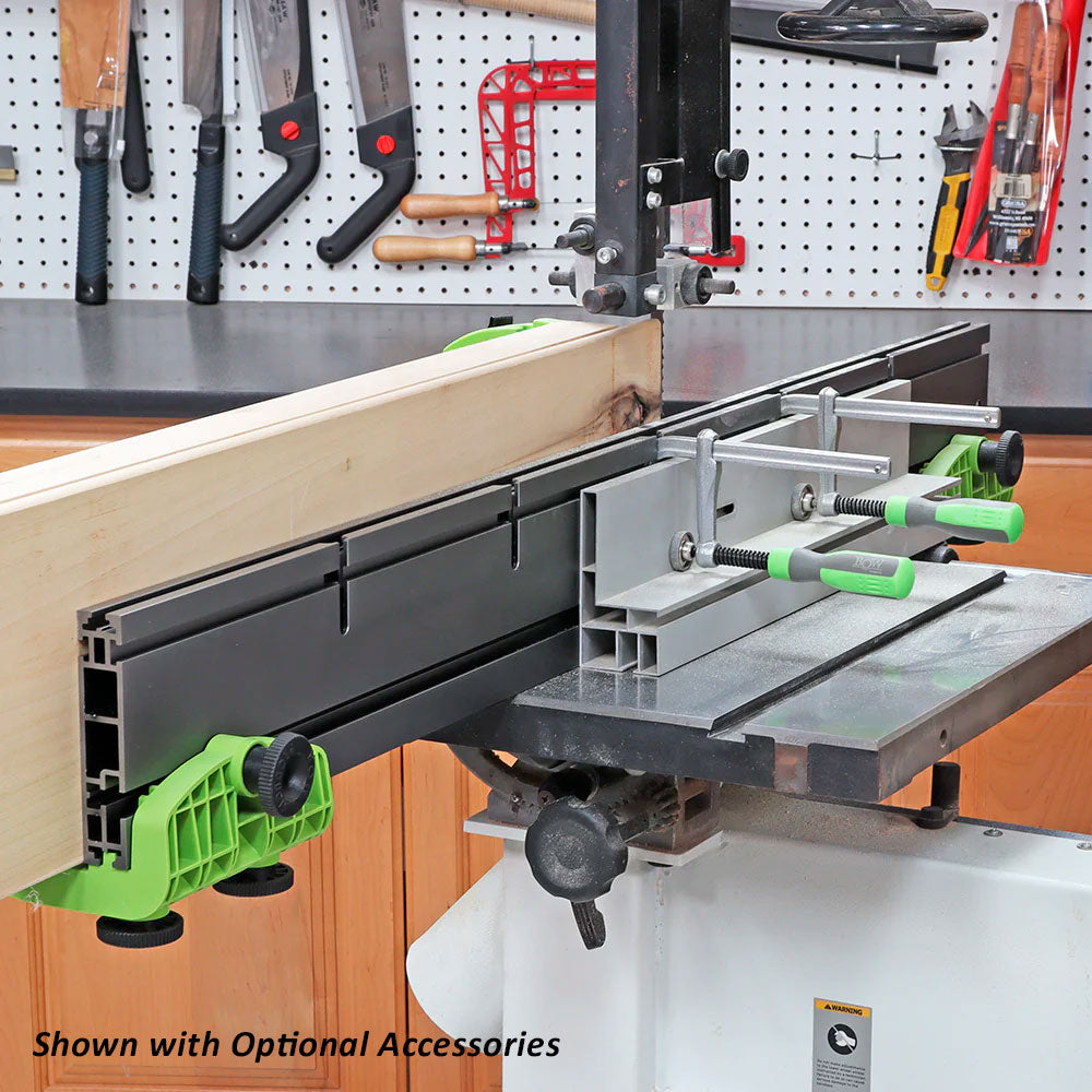 Band saw fence system with clamps and wood, woodworking tools in background