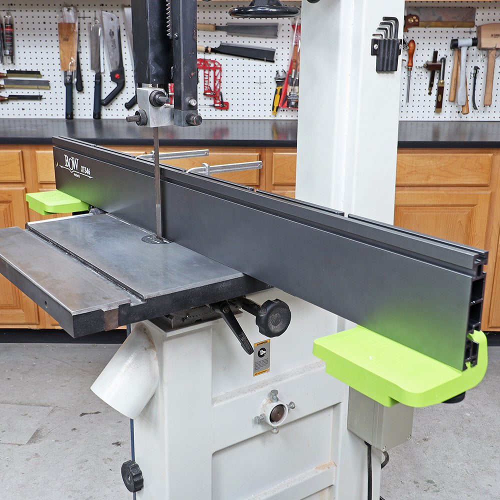 Band saw machine with adjustable fence and workbench in a woodworking shop