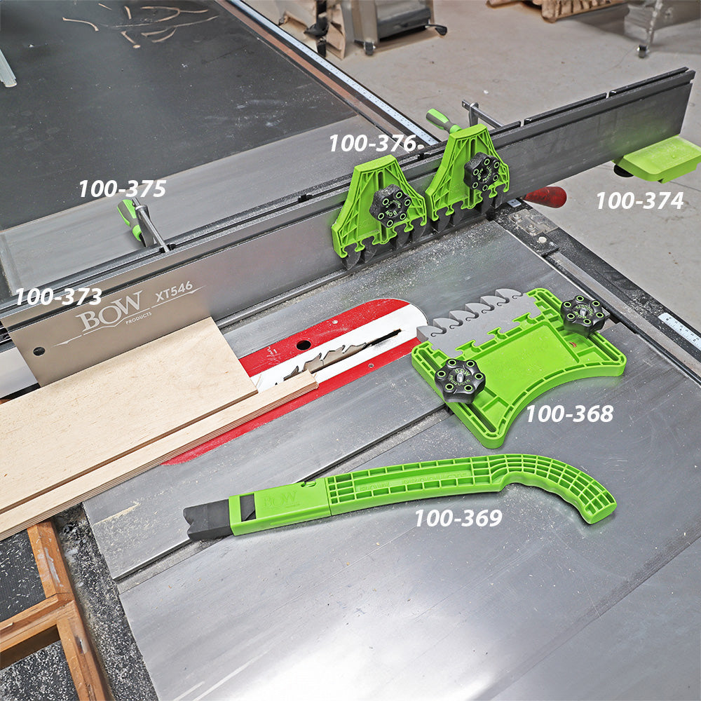 Green woodworking table saw accessories and push sticks on a saw with labeled parts.