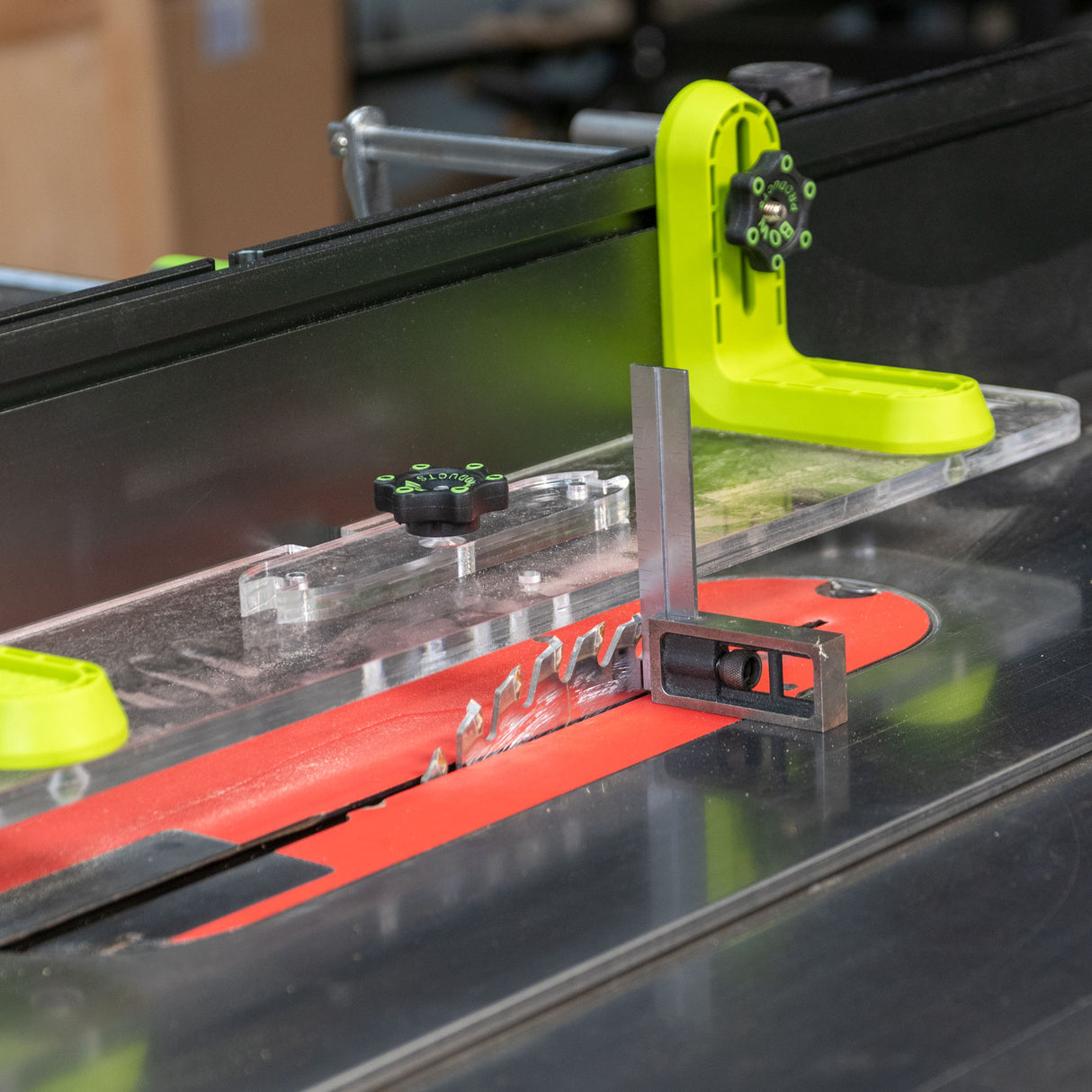 Table saw setup with precision fence system, blade, and L-shaped measuring tool