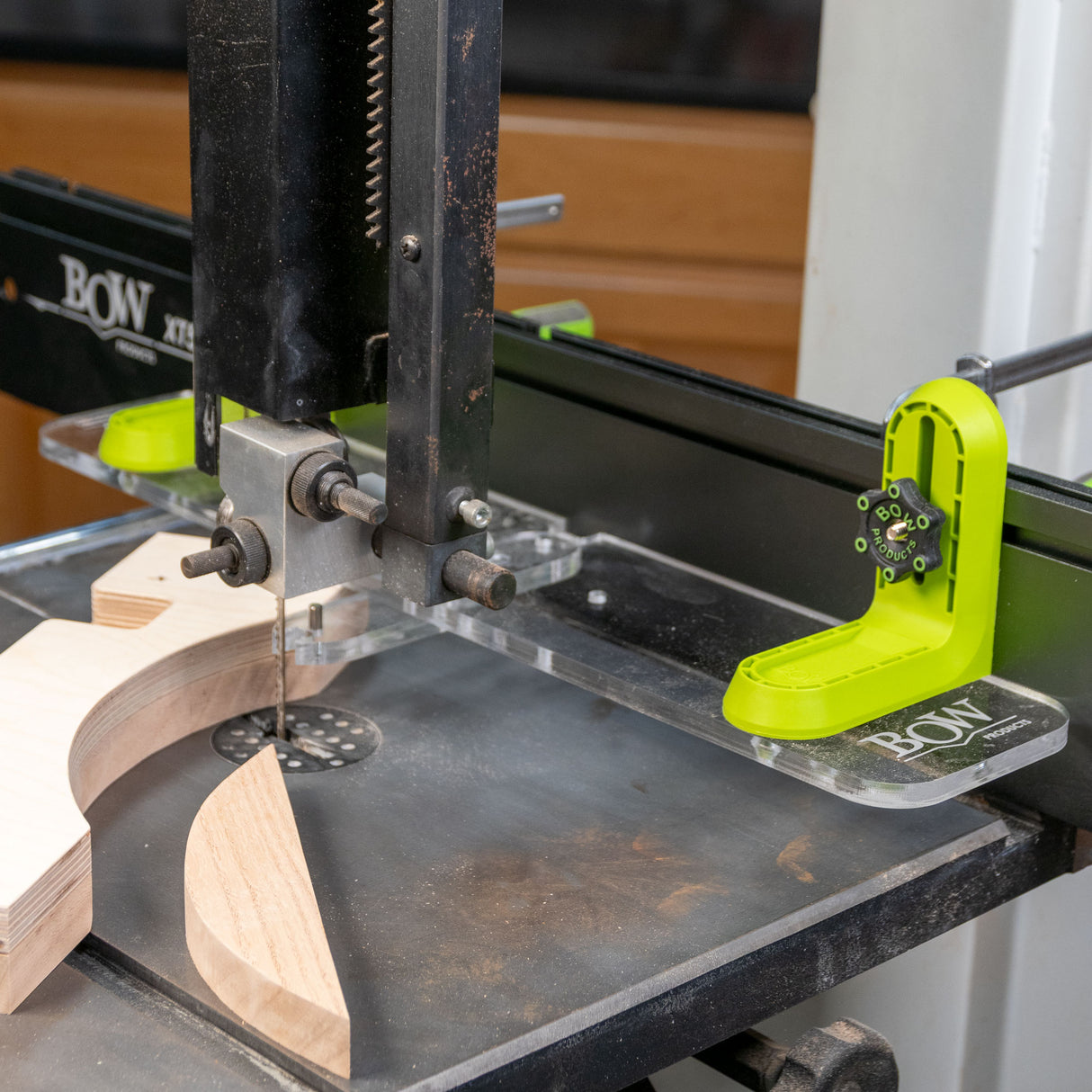 Band saw with L-fence and Bow woodworking guide cutting curved wood pieces