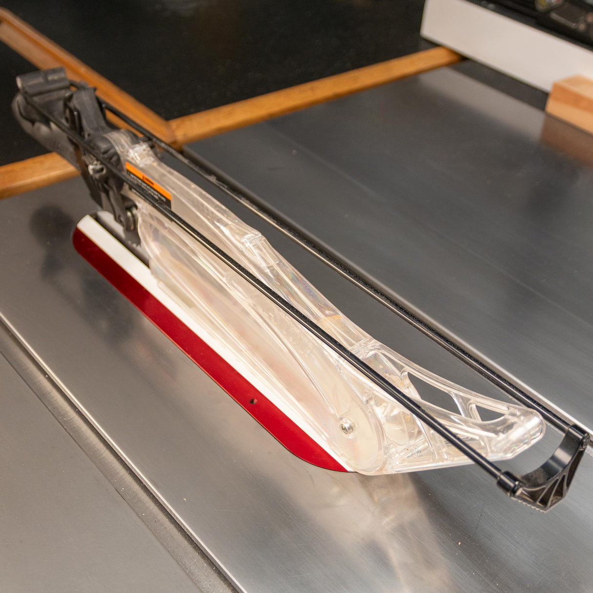 Clear blade guard and red zero-clearance insert installed on a table saw