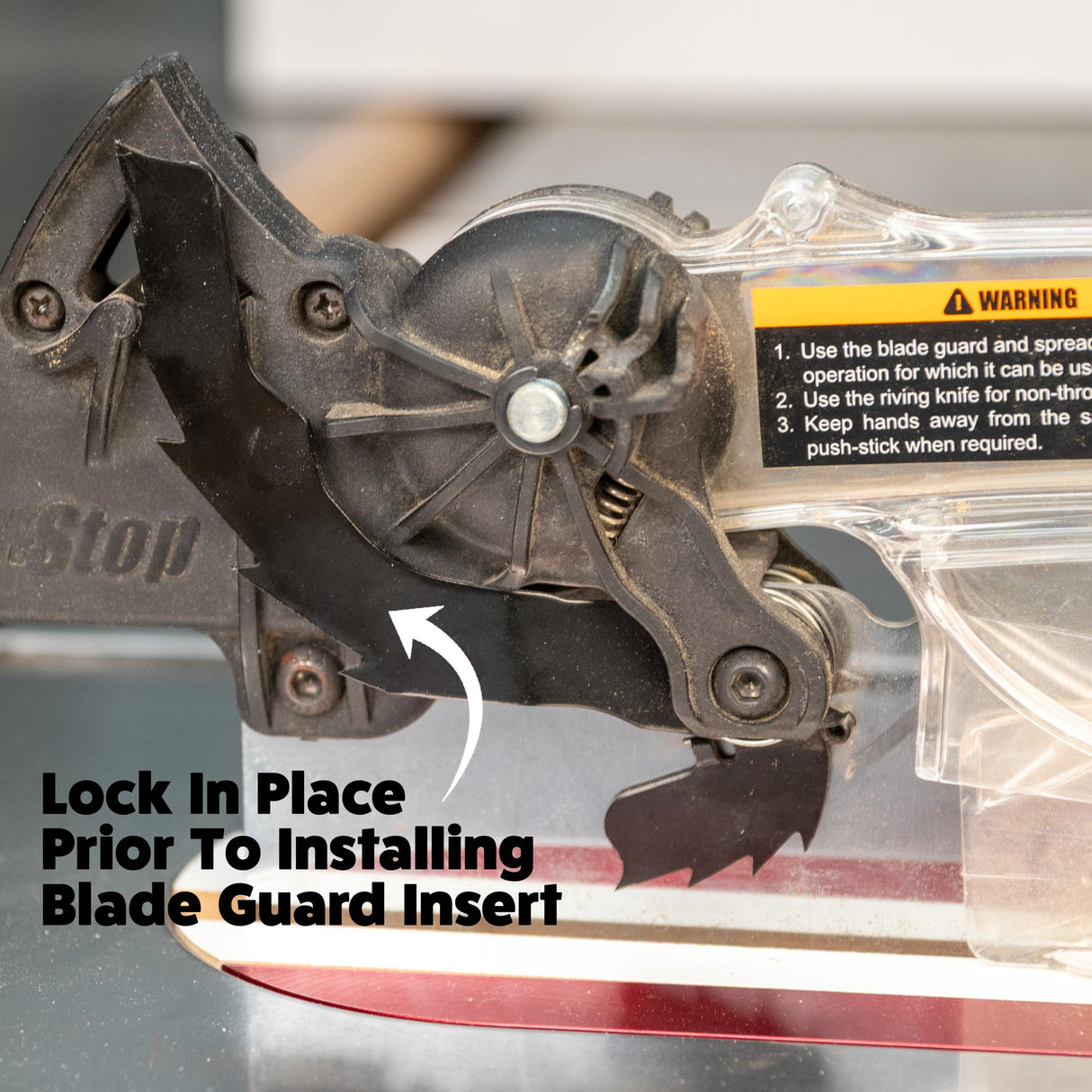 SawStop table saw blade guard installation with instructions and riving knife visible