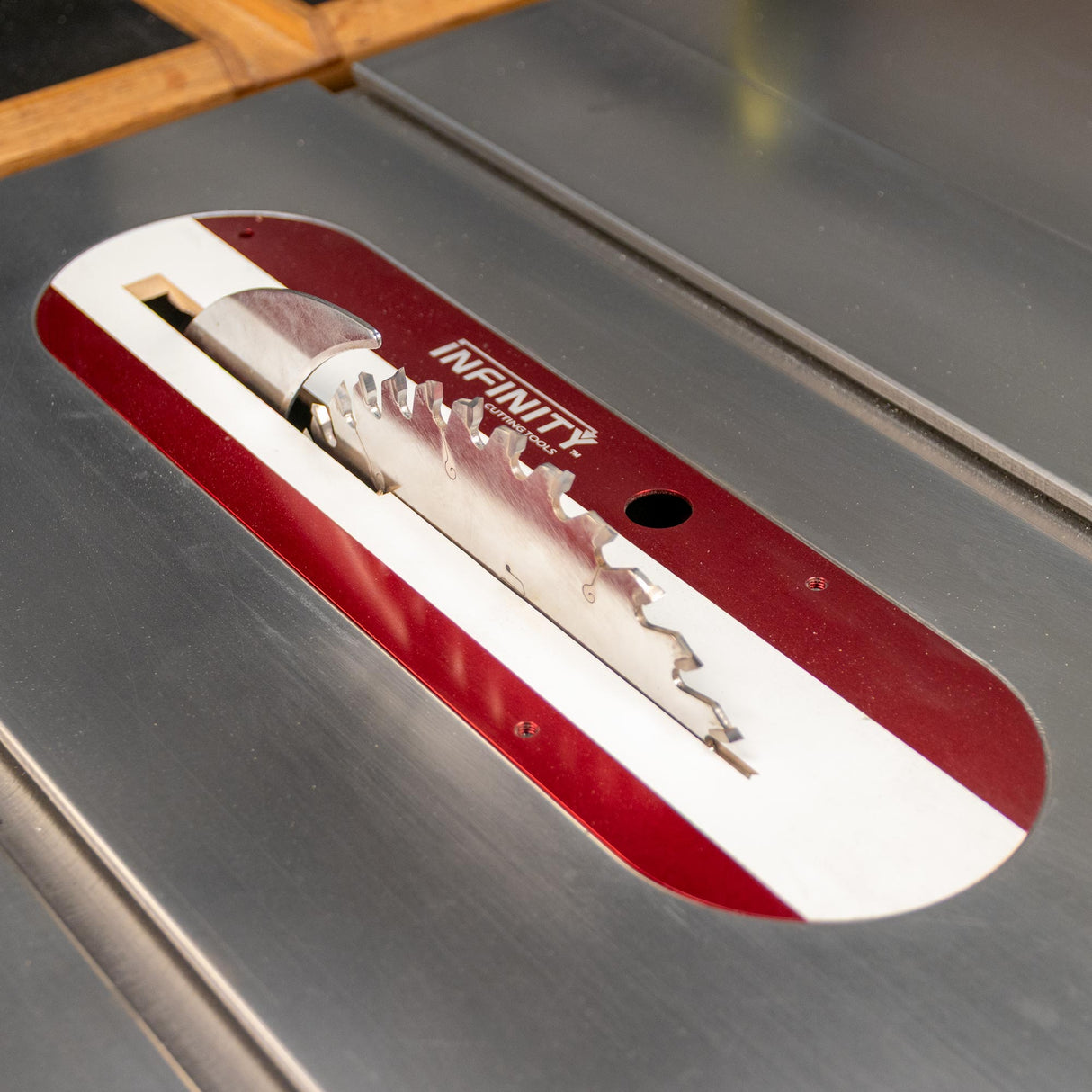 SawStop table saw with zero clearance insert and blade, installed in a woodworking setup