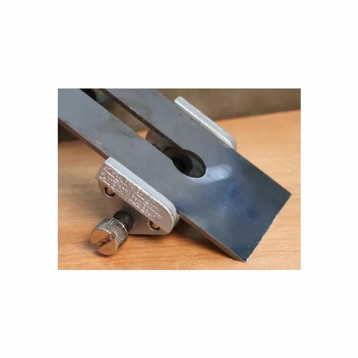 Honing guide tool for sharpening woodworking plane blades on a wooden surface