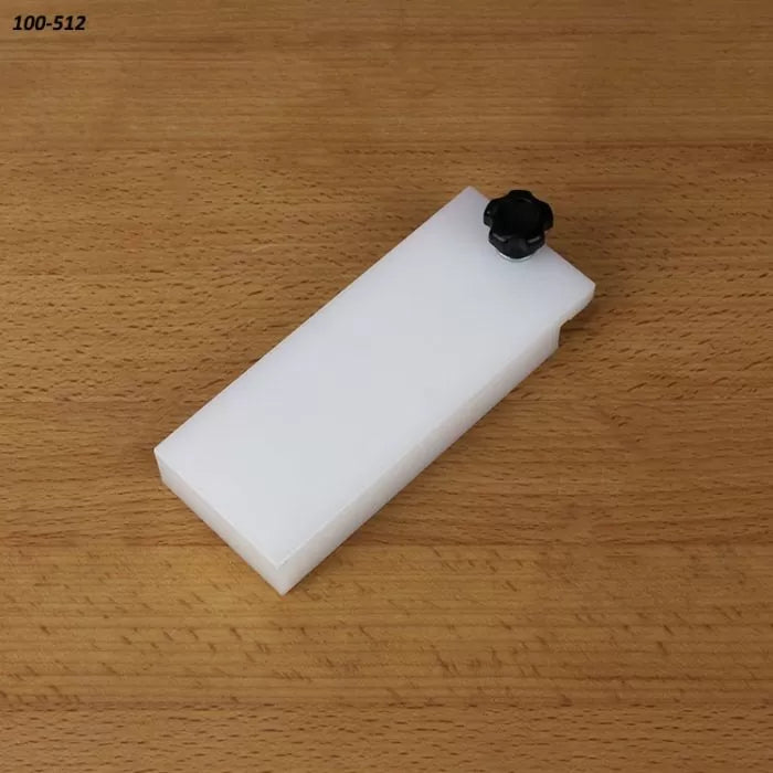 Rectangular white table saw accessory with black knob on wood surface, woodworking tool