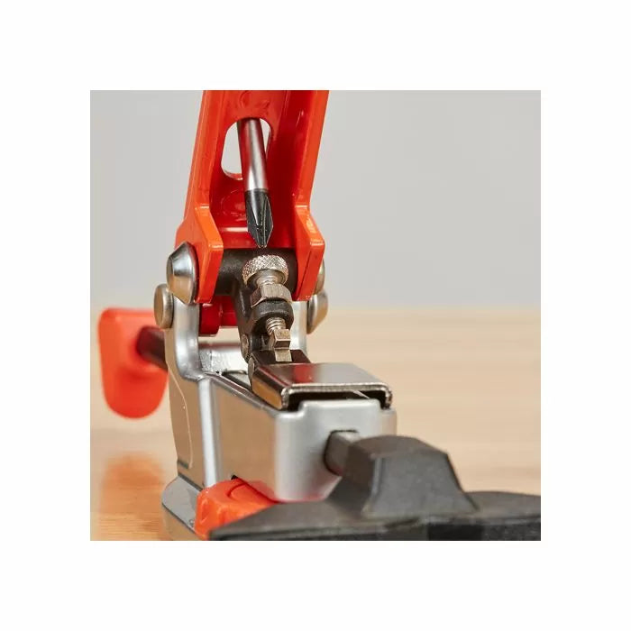 Woodworking pocket hole jig clamp with screwdriver on wooden surface