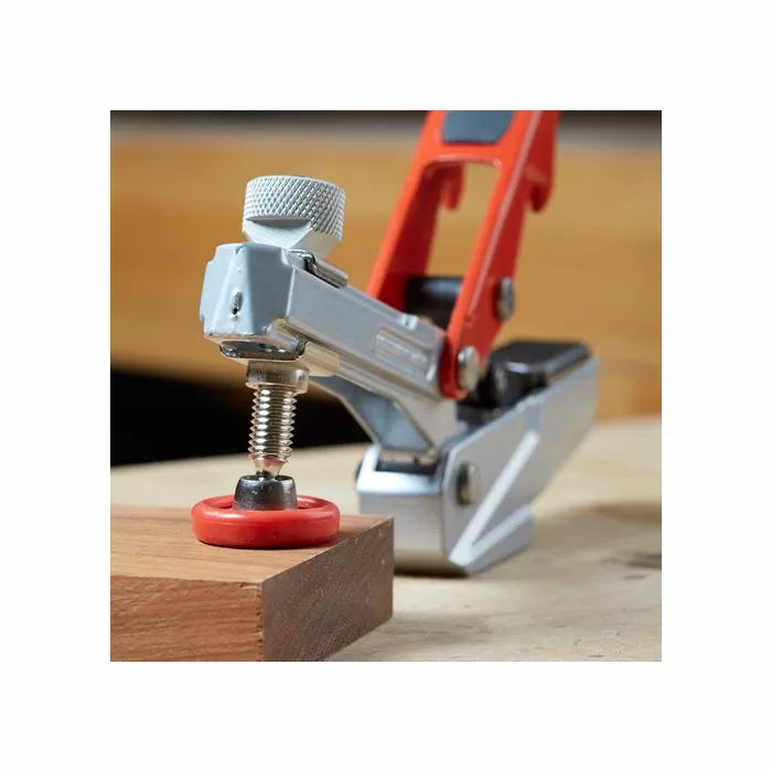 Toggle clamp holding wood on a workbench, woodworking tool for secure clamping