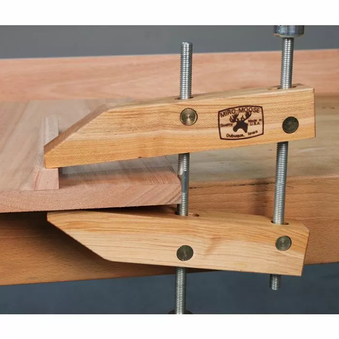 Wooden handscrew clamp securing a woodworking project on a workbench