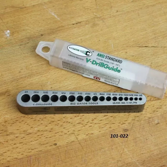 V-DrillGuide metal drill bit guide for woodworking on a workbench with storage case