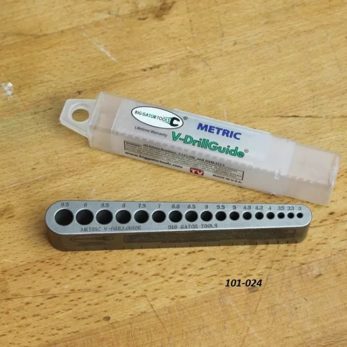 Metric V-DrillGuide drill bit guide with labeled sizes on a woodworking bench