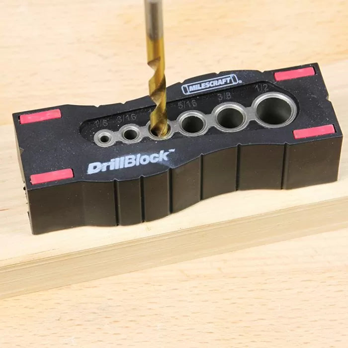 Woodworking drill guide block with drill bit in use on a wooden board