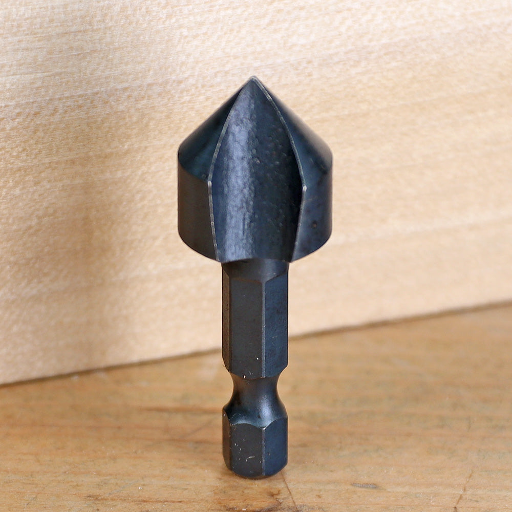 Steel countersink drill bit for woodworking on a wooden surface