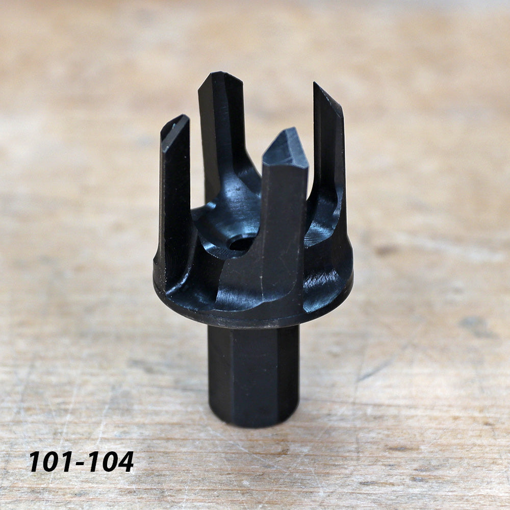 Four-blade black woodworking tenon cutter tool on a wooden surface