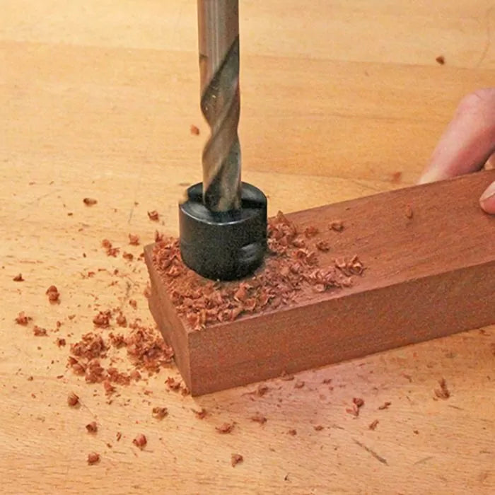 Drill bit with stop collar drilling into wood, creating precise hole and wood shavings