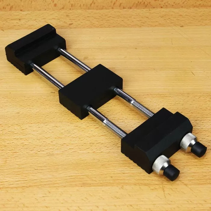 Knife sharpening honing guide on a wooden workbench for woodworking tools