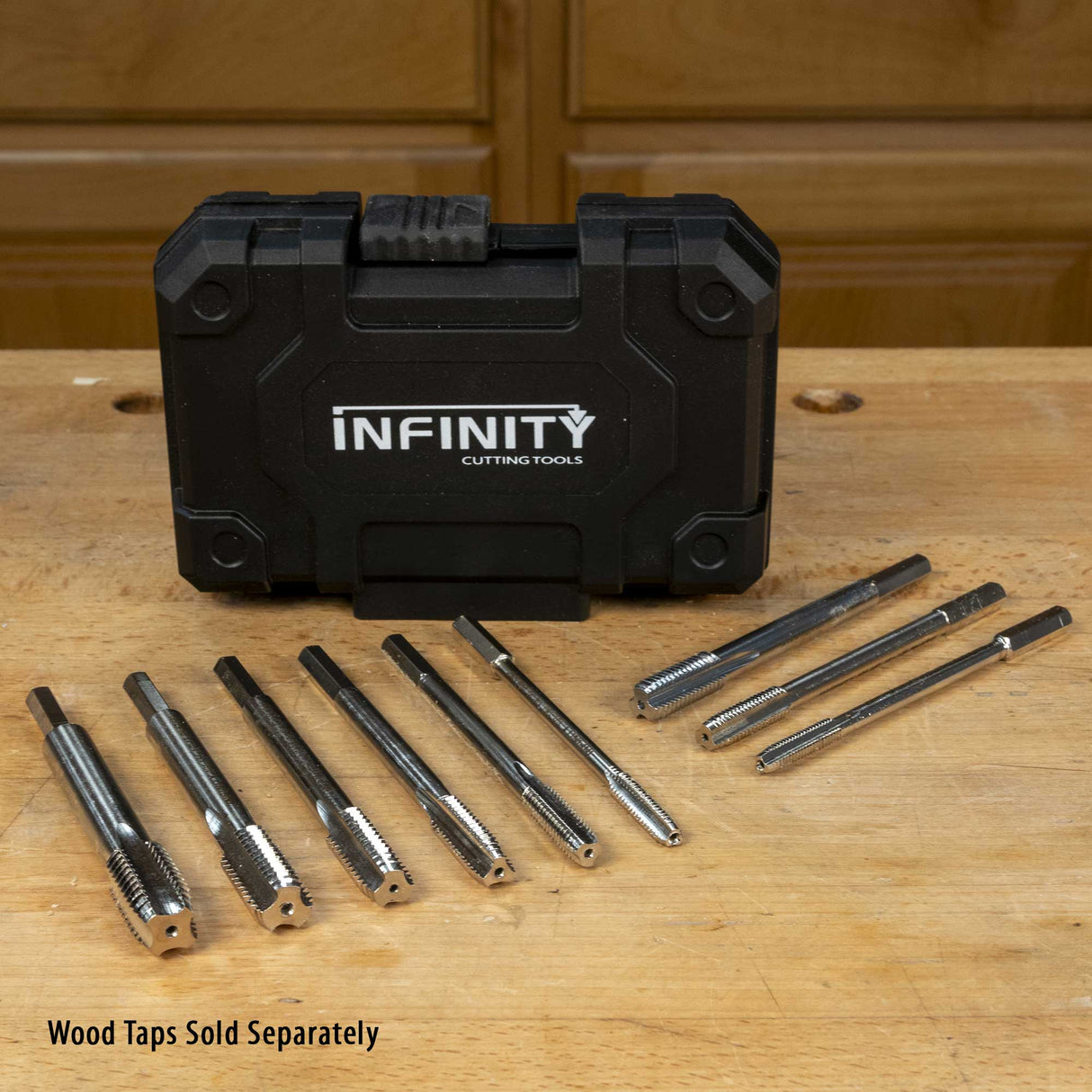 Metal tap set with storage case on a workbench, wood taps sold separately