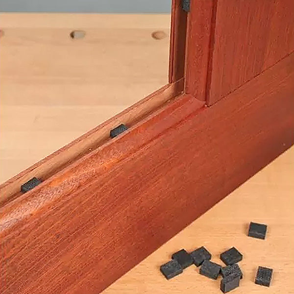 Wooden frame with black rubber panel spacers for woodworking on a workbench