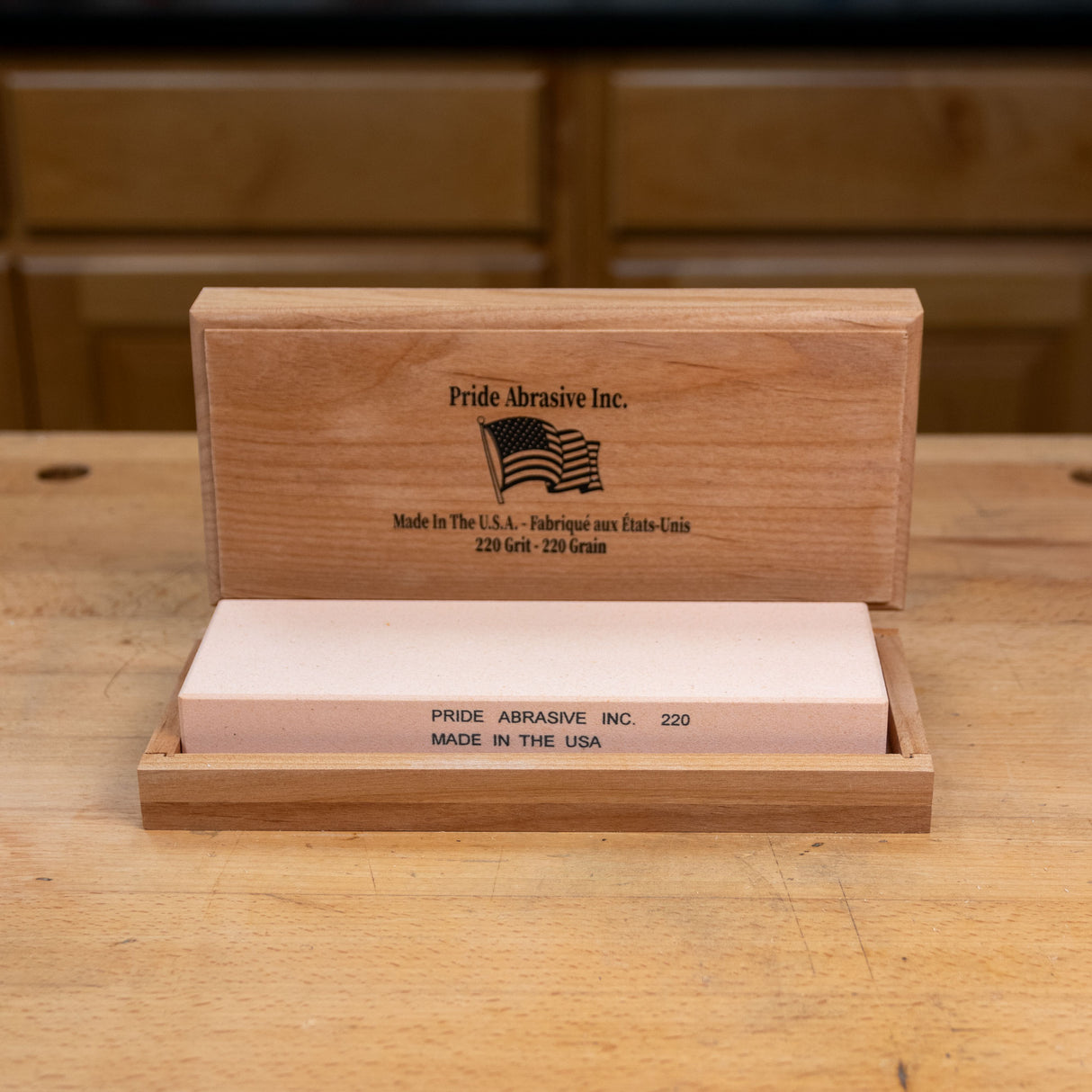 220 grit waterstone sharpening stone in a wooden box on a woodworking bench