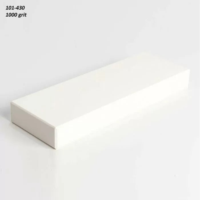 Rectangular 1000 grit sharpening stone for woodworking tools on a plain surface.