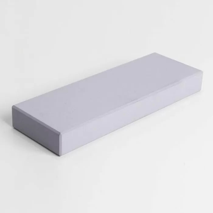 Rectangular sharpening stone for woodworking tools on plain white background