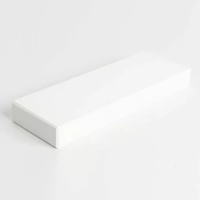 Rectangular white sharpening stone for woodworking tools on a plain background