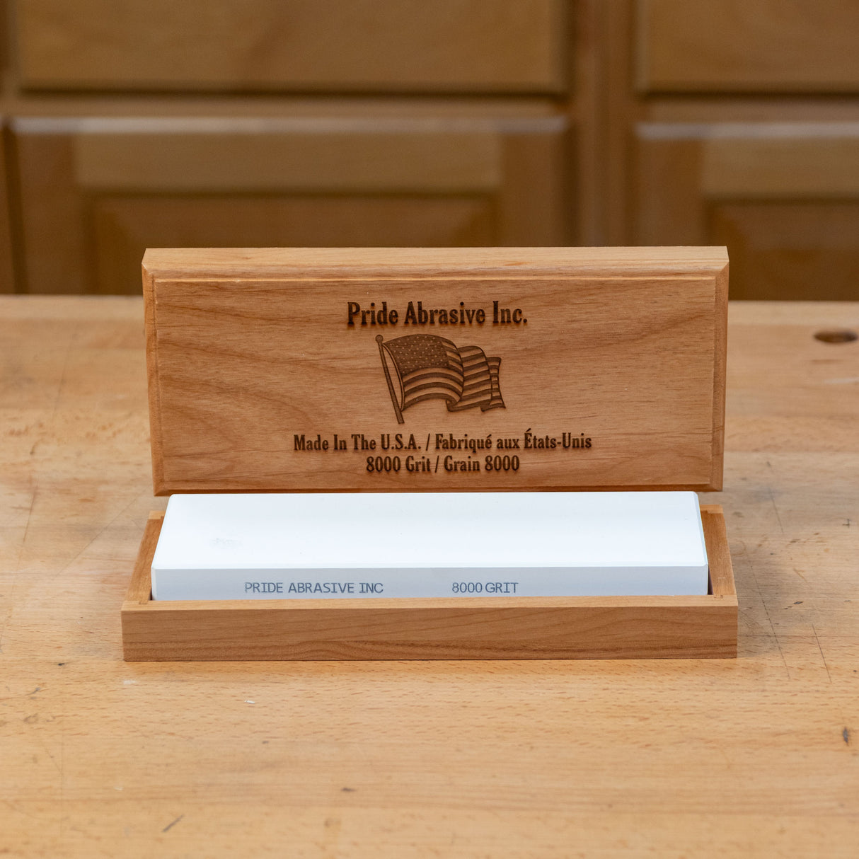 8000 grit sharpening stone in a wooden box on a woodworking bench