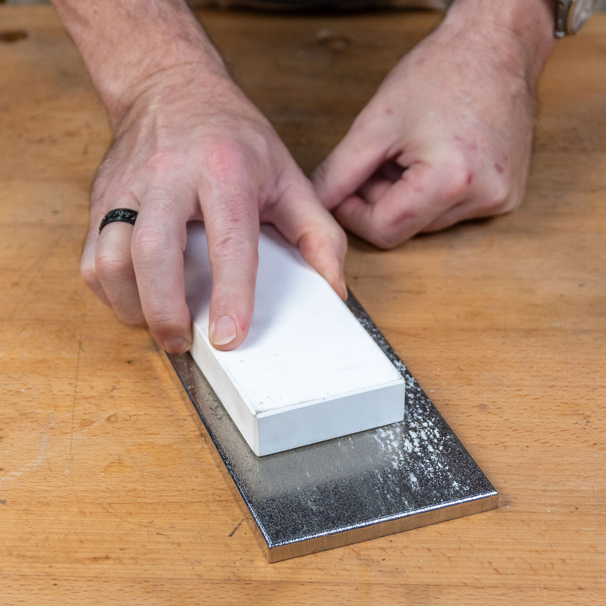 Hand flattening a sharpening stone on a diamond lapping plate for woodworking tool maintenance