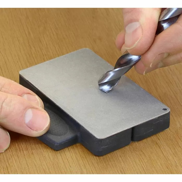 Sharpening a drill bit on a flat diamond sharpening stone for woodworking