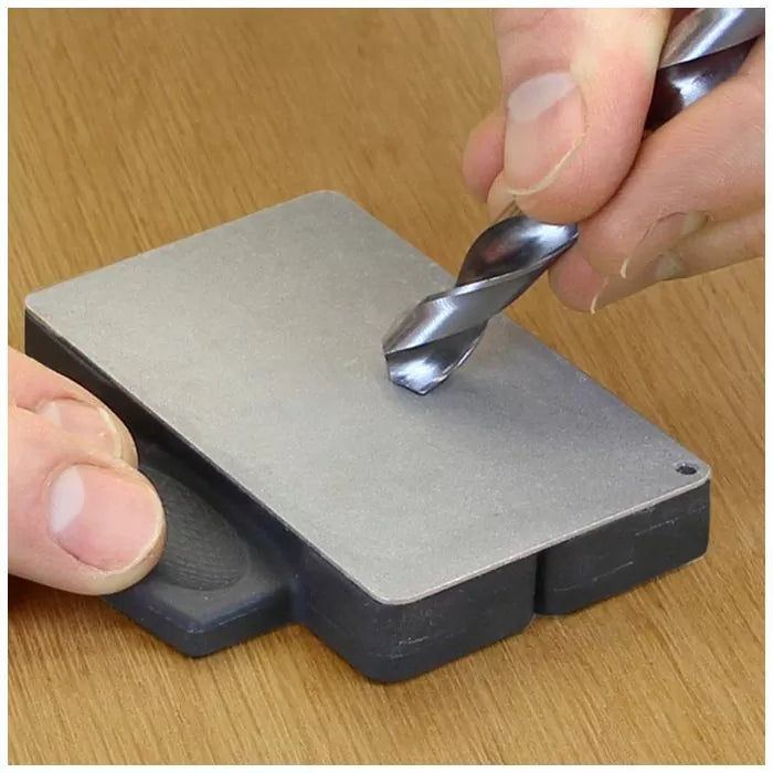 Hand sharpening drill bit on diamond bench stone for woodworking tool maintenance