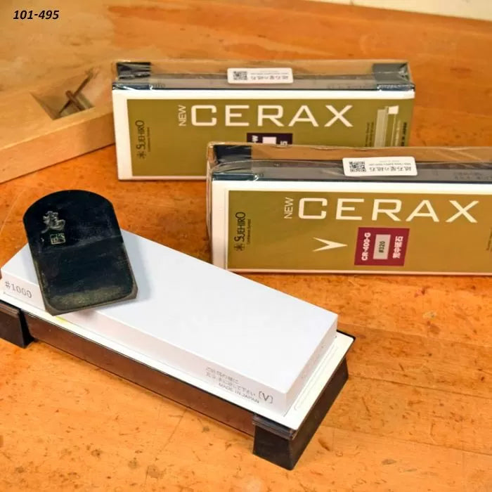 Cerax sharpening stones and plane blade on wooden workbench, woodworking tool accessories