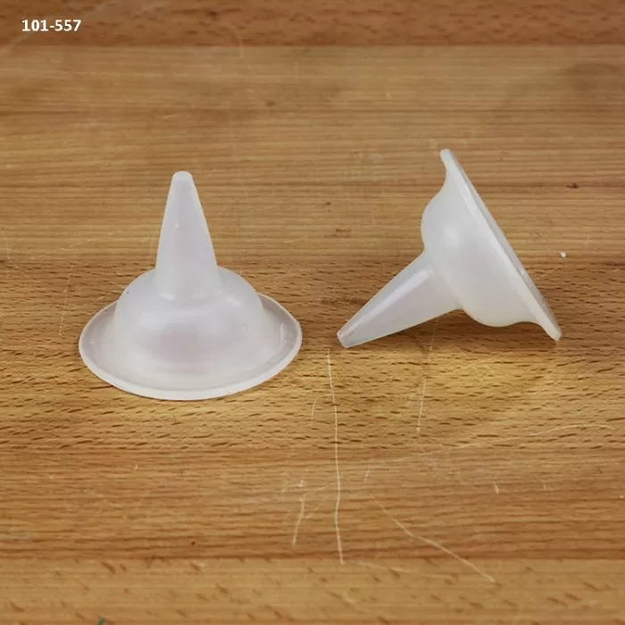 Two clear plastic glue bottle tips on a wooden surface for woodworking projects.