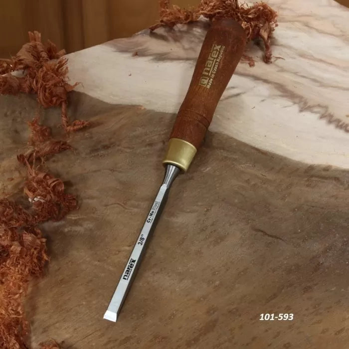 Woodworking chisel with wooden handle on burl wood, surrounded by wood shavings