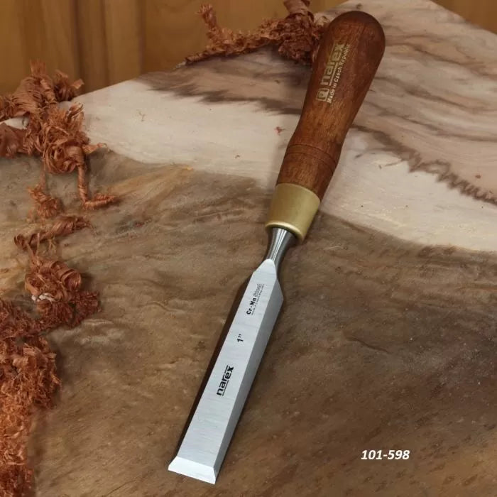 Wood chisel with wooden handle and sharp steel blade on a workbench with wood shavings