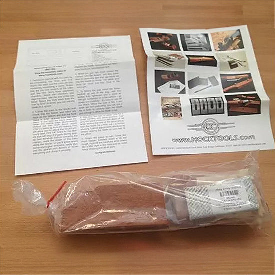 Woodworking tool kit with instruction sheets on a wooden surface