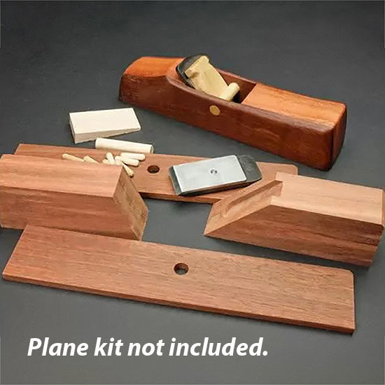 Wooden hand plane body parts, blade, and dowels for woodworking assembly on black surface