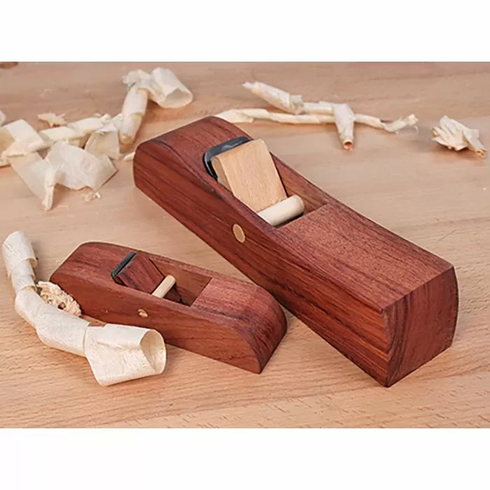 Wooden hand planes on workbench with wood shavings, woodworking tools for precision planing