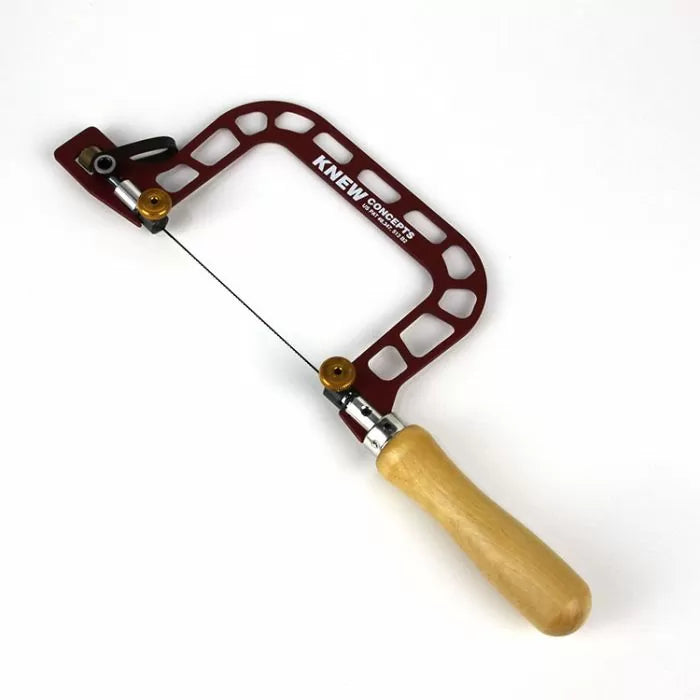 Precision woodworking coping saw with red open frame and wooden handle on white background