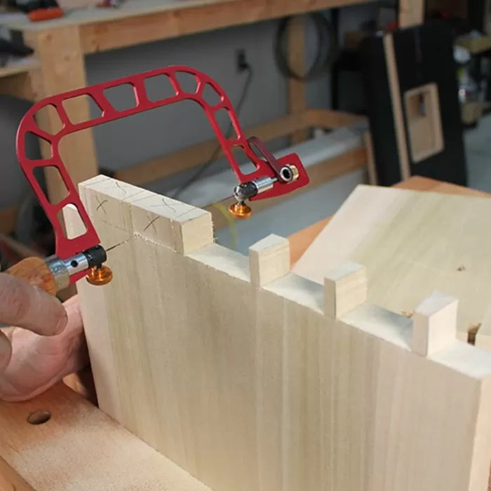 Dovetail marking jig clamped on wood for precise joinery in woodworking workshop